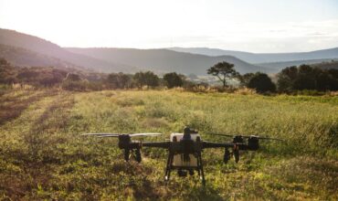 A drone surveying a lush forest, showcasing modern forestry mapping techniques and technology in action.